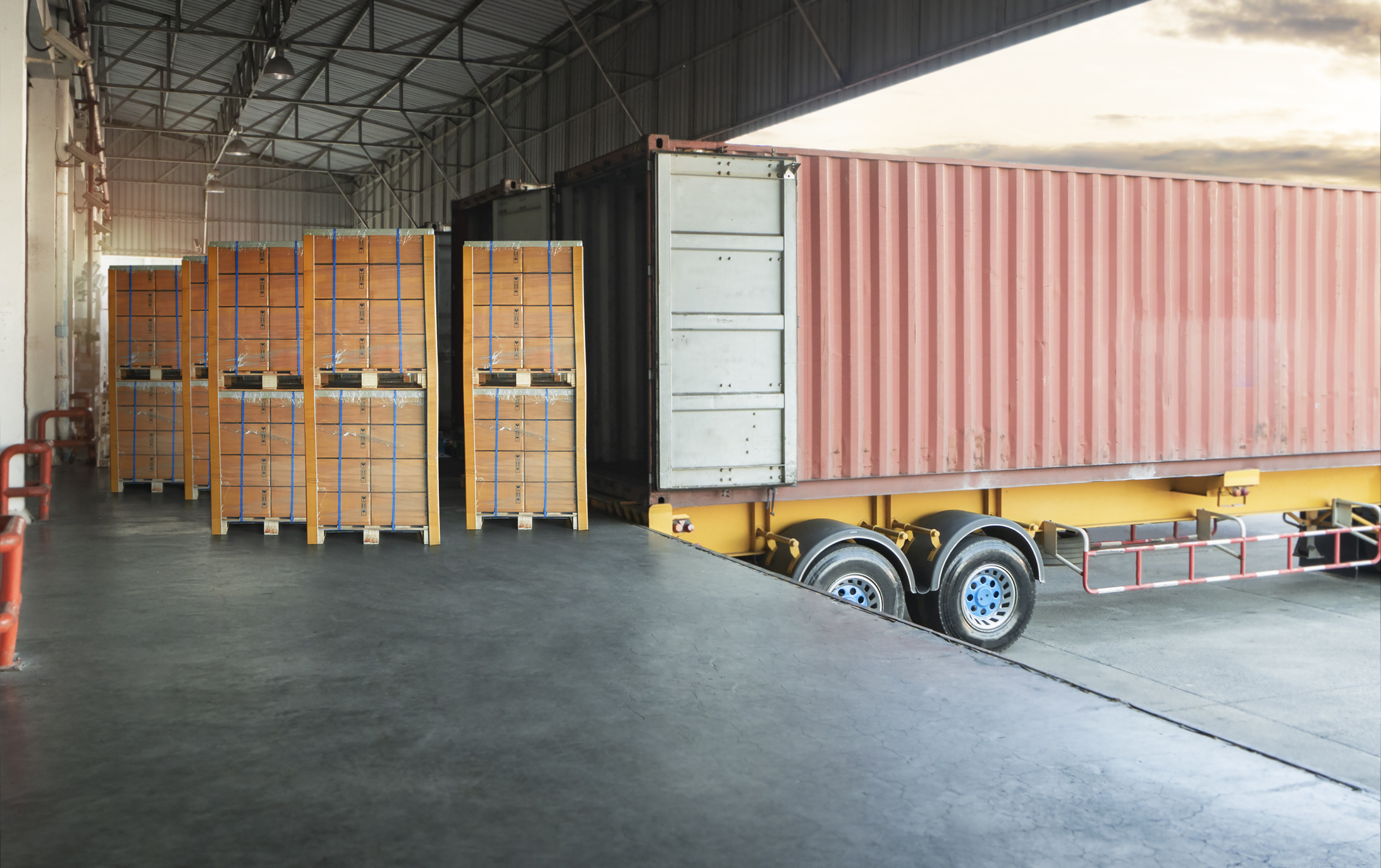 Packaging Boxes Stacked On Pallets Loading Into Cargo Container. Shipping Trucks. Supply Chain. Shipment Boxes. Distribution Supplies Warehouse. Freight Truck Transport Logistics.